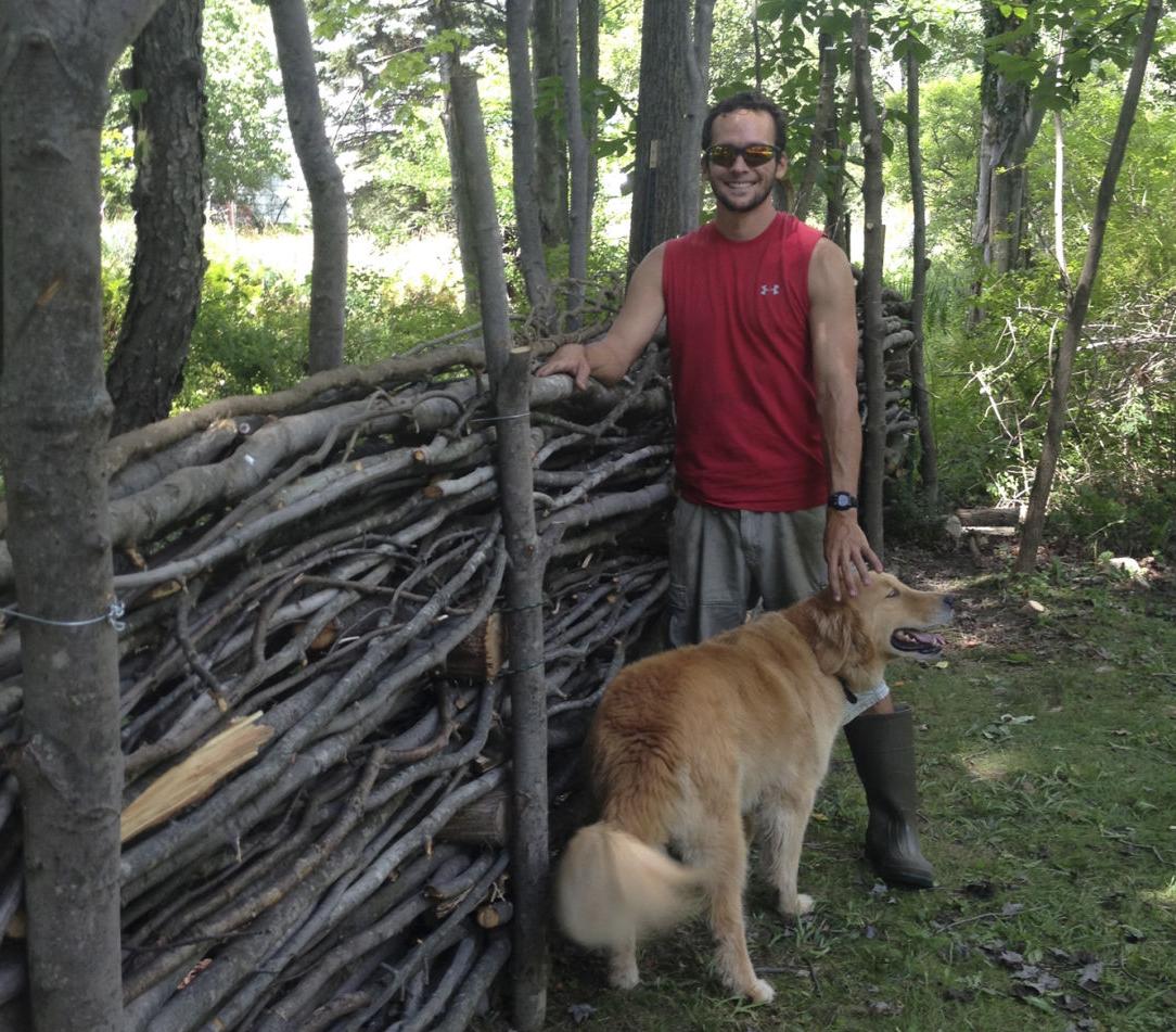 WWOOFer Sean Dixon-Sullivan with brush fence